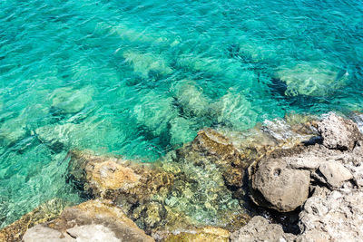 High angle view of rocks by sea