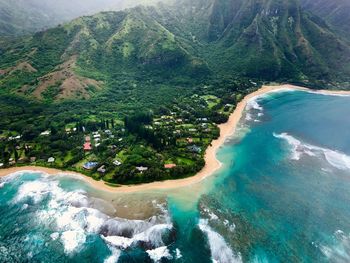 Scenic view of sea and mountains against sky