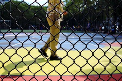 Close-up of chainlink fence against blue sky