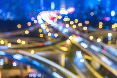 Defocused image of illuminated city at night