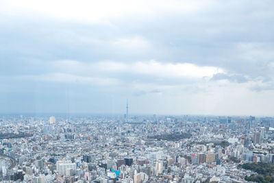 High angle view of city against cloudy sky