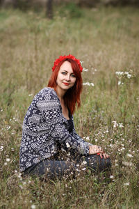 Young woman sitting on field