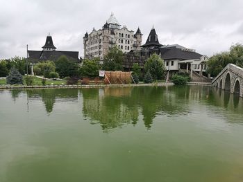 Reflection of building in lake against sky