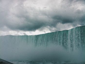 Scenic view of sea against cloudy sky