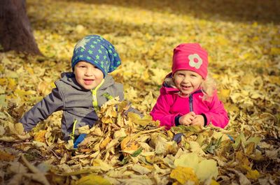 Portrait of smiling boy with autumn leaves