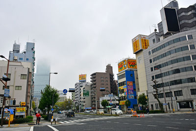 City street and buildings against sky