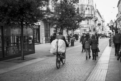 Rear view of woman walking on road in city