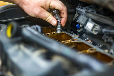 Cropped hand of man repairing car