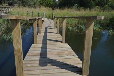 Wooden footbridge over lake