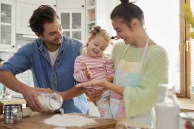 Family preparing food in kitchen