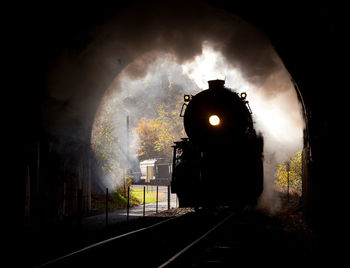 Train on illuminated railroad track at night