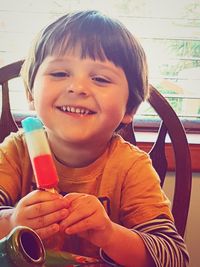 Portrait of smiling boy holding ice cream