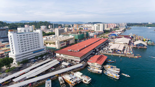 High angle view of cityscape by sea against sky