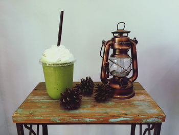 Close-up of coffee on table against wall