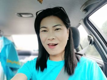 Portrait of smiling young woman in car