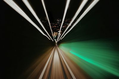 Light trails on street against city at night