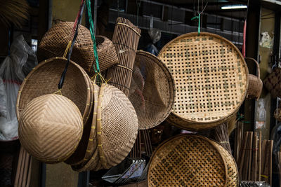Low angle view of wicker containers hanging for sale in market