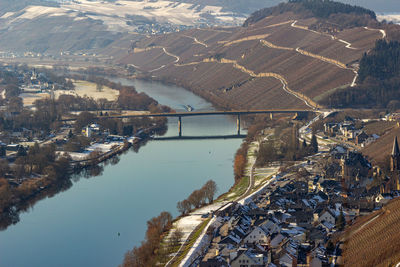 View on the valley of the river moselle and the wine villages mülheim and lieser in winter with snow
