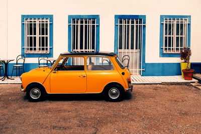 Vintage car on street against building