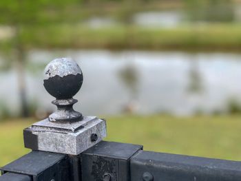 Close-up of metal railing in park