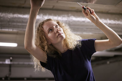 Low angle view of woman checking air duck