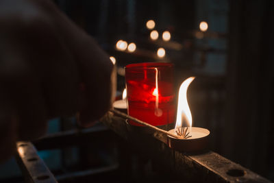 Close-up of illuminated tea light on table