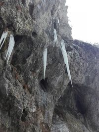 Low angle view of waterfall on cliff