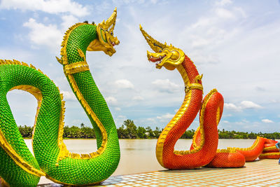 Close-up of animal sculpture against sky