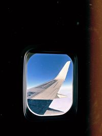Airplane wing seen through window