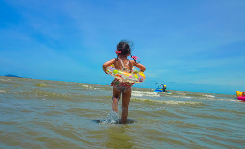 Full length of boy on beach against sky