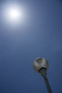 Low angle view of communications tower against sky