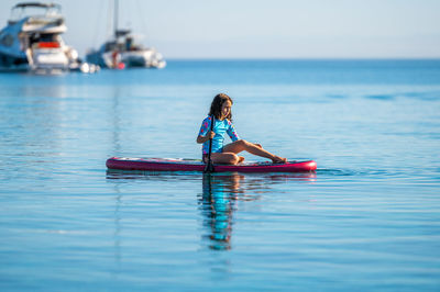 Man kayaking in sea