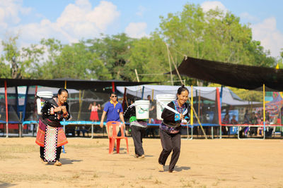 Rear view of children playing on landscape