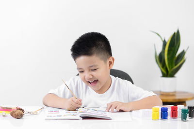 Portrait of boy holding table