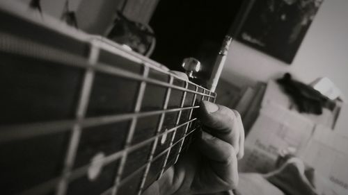 Cropped image of man playing guitar