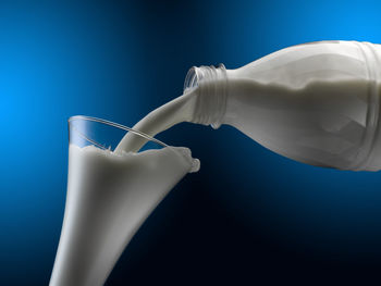 Close-up of drink pouring over white background