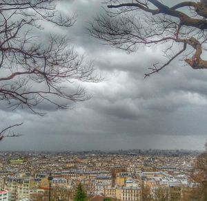 Buildings against cloudy sky