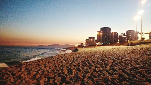 View of calm beach against clear sky