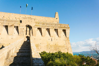 Low angle view of fort against sky at magliano in toscana