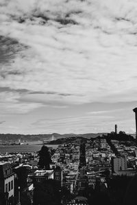 High angle view of cityscape against cloudy sky