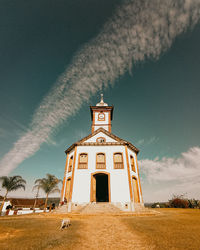 Built structure on field against sky