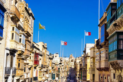 Low angle view of buildings against blue sky