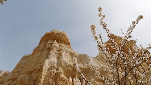 Low angle view of rock formation against sky