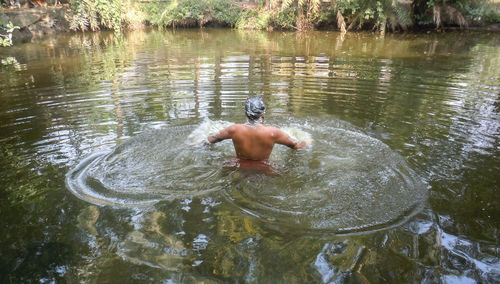 High angle view of man swimming in lake