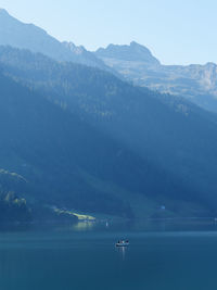 Scenic view of sea and mountains against sky