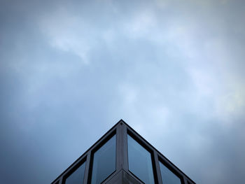 Low angle view of windows of a building against sky