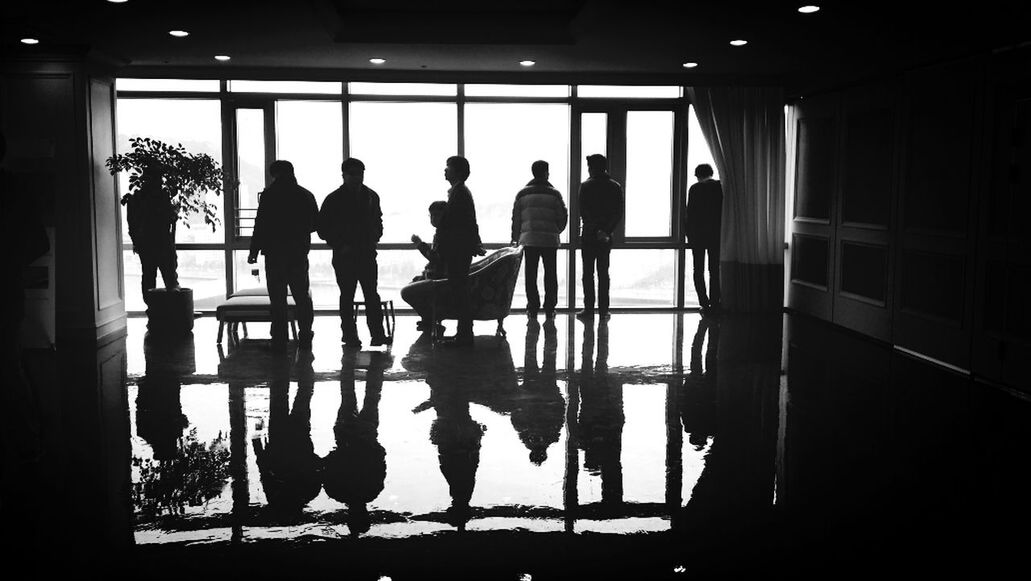 indoors, men, person, silhouette, window, lifestyles, standing, flooring, illuminated, in a row, togetherness, side by side, reflection, glass - material, corridor, tiled floor, leisure activity, chair, sitting