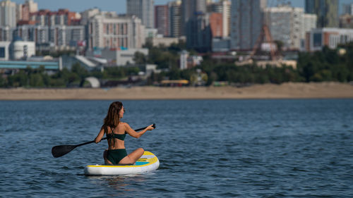 Full length of woman on boat in sea