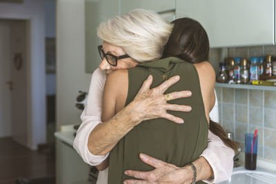 Midsection of couple standing at home