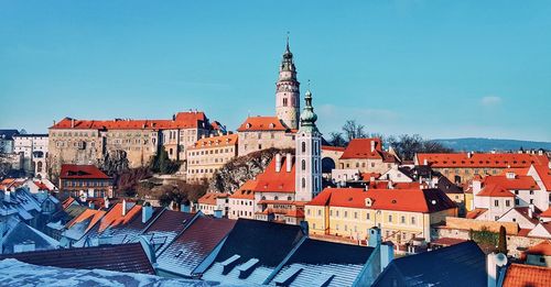 Buildings in city against clear sky